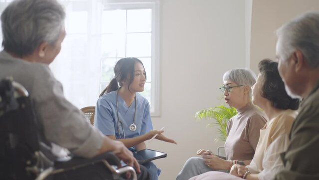 Group of Asian senior people sit in a circle in a nursing home and used stethoscope place on chest to listen the heart beating