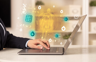 Doctor working on laptop with healthcare concept