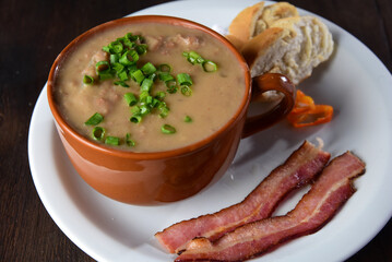 delicious bean broth with bacon, bread and pepper, typical Brazilian food