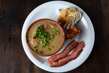 delicious bean broth with bacon, bread and pepper, typical Brazilian food
