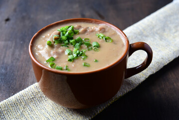 delicious bean broth with bacon, bread and pepper, typical Brazilian food