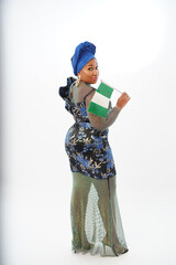 Portrait of beautiful Nigerian woman carrying the national flag