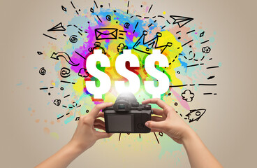 Close-up of a hand holding digital camera with abstract drawing concept