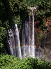 waterfall in the middle of the forest and rainbow. Lumajang, Indonesia.
