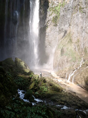 Fototapeta na wymiar man standing in front of the waterfall
