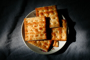 Stack of square crackers on plate