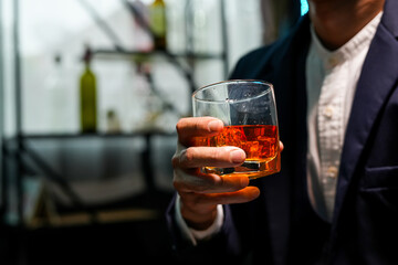 Closeup businessmen holding a glass of whiskey