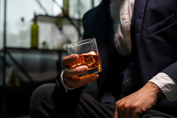 Closeup businessmen holding a glass of whiskey