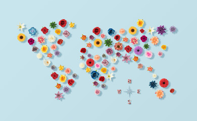 Creative layout world map made with various spring flowers background. Flat lay. Nature concept.