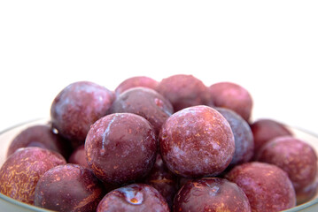 Purple plums on white background