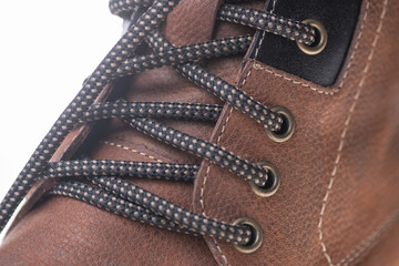 Fragment of fashionable men's brown winter boot made of genuine leather with fur.