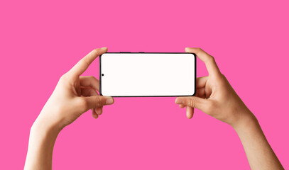 Person using mobile phone with empty white screen on bright pink background