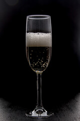 Champagne glass on black background