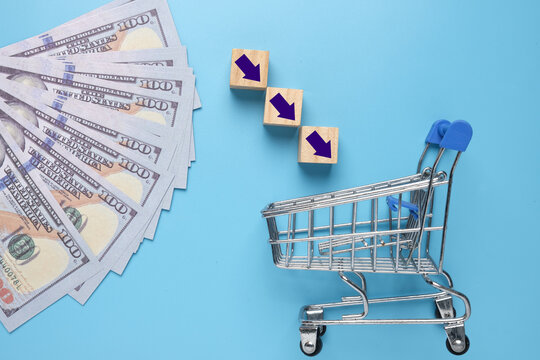 A picture of cart, arrow and fake cash. Online shopping and buy more concept.