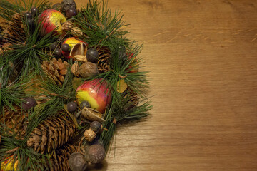 Happy Holidays and New Year. Christmas wreath with decorations on a wooden table. Retro fashion.