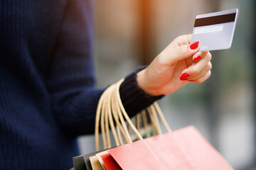 woman person holding a wallet in the hand of a  take credit card out of pocket. Cost control expenses shopping in concept. Leave space to write descriptive text.
