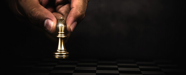 Hand choose king chess on cheeseboard concept of challenge or team player or business team and leadership strategy or strategic planning and human resources organization risk management. - obrazy, fototapety, plakaty