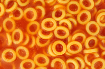 Spaghetti hoops in a juicy tomato sauce food background