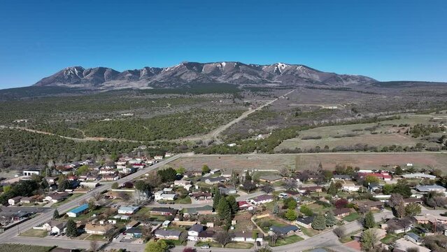 Aerial Monticello Utah rural neighborhood pull part 2. Settled in July 1887 by pioneers from The Church of Jesus Christ of Latter-day Saints. Farming, ranching, and uranium mining. Mountain valley.