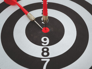 Target Red darts placed in the center of the target The goal idea that has been set has been...