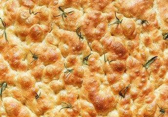 Homemade rosemary focaccia bread, above view, close up.