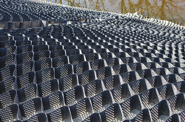 Old geogrid to strengthen the slope. Strengthening the slope with a geogrid.
