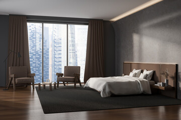 Stylish bedroom interior with bed, nightstands, and two armchair
