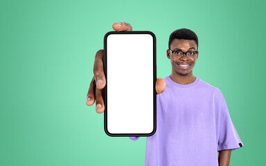 Fototapeta na wymiar Happy african man show smartphone, mockup display on bright back