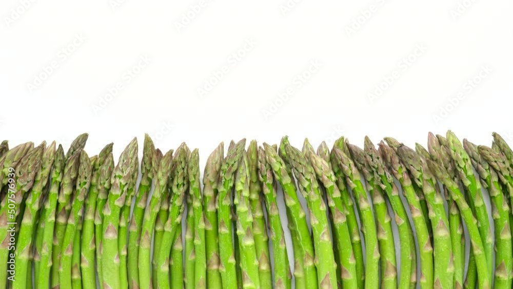 Wall mural fresh asparagus on white background, sliding shot. healthy food concept