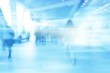 blue background blurred movement of people shopping mall