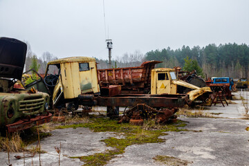 Old rusty abandoned damaged trucks in Chernobyl exclusion zone, Ukraine