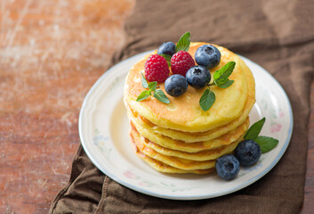 Stack of pancakes with fresh berries, close-up.