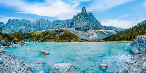 Majestic landscape of  Dolomites lake Sorapis with colorful larches and high mountains. Wonderful...