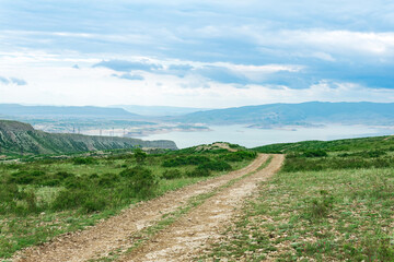 mountain landscape with dirt road in the vicinity of the reservoir of the Chirkey hydroelectric power station in Dagestan