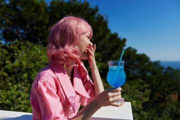 portrait of beautiful woman drinking a cocktail on the terrace Relaxation concept