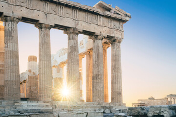 Pinnacle of the Parthenon. The summer sun sets behind its marble pillars. 