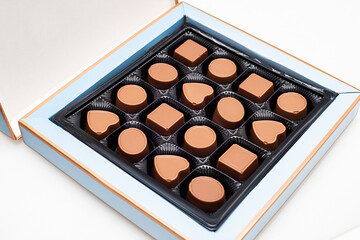 a box of chocolates of various shapes and flavors. The concept of a first date and confectionery sweets