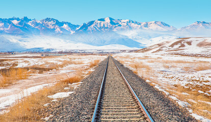 A railroad to the snowy mountain range - Powered by Adobe