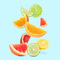 Fresh juicy citrus fruits on turquoise background
