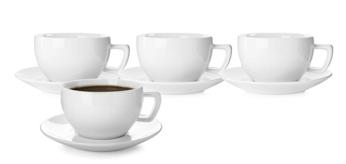 Empty ceramic cups and one with aromatic coffee on white background. Banner design