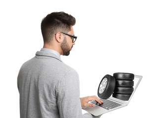 Man buying car tires from online auto store via laptop on white background. Delivery service