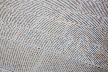 New carved paving made with chiseled grey sandstone blocks in a pedestrian zone