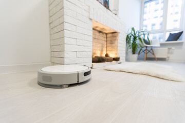 Automated vacuum cleaning robot powered by rechargeable battery in modern living room