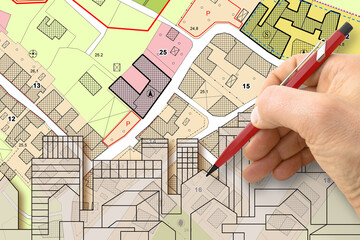Architect drawing buildings over an imaginary cadastral map of territory and General Urban Plan with indications of urban destinations with buildings, roads, buildable areas and land plot