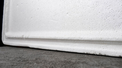 building material styrofoam on gray concrete table, abstract horizontal background