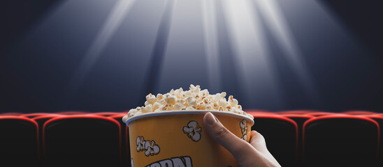 Woman eating popcorn at the cinema - obrazy, fototapety, plakaty