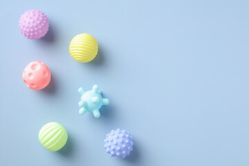 Fototapeta na wymiar Baby balls toys for bath on blue background. Flat lay, top view. Minimal style.