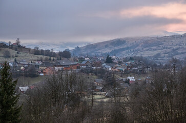 Winter coming. Cloudy and foggy morning very late autumn mountains scene. Peaceful picturesque traveling, seasonal, nature and countryside beauty concept scene. Carpathian Mountains, Ukraine.