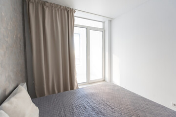 Fototapeta premium bedroom in a minimalist style. Bed for two with blanket and pillows
