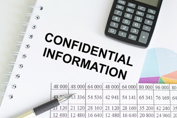 business concept. Notebook with text confidential information on table next to calculator, pen and reports
